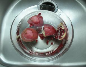 Clean pomegranate quarters in water